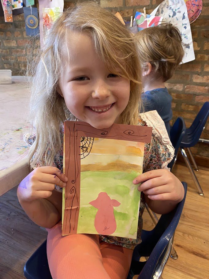 IMG_0364 A little girl holding up an art project.