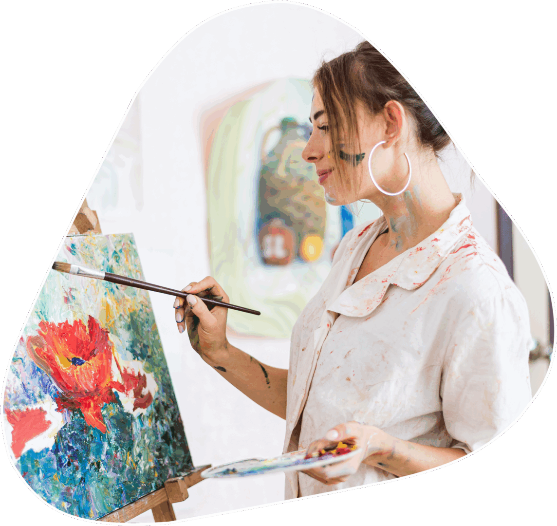 A woman painting with paintbrush and canvas.
