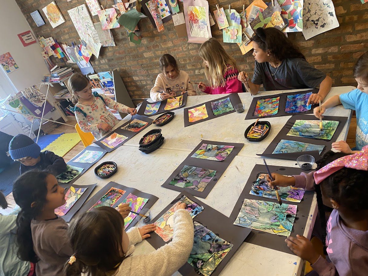 A group of children sitting around a table.