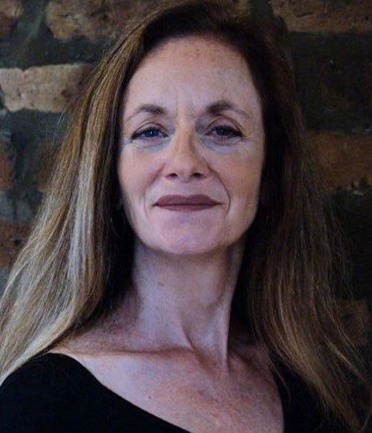 A woman with long hair and a black shirt