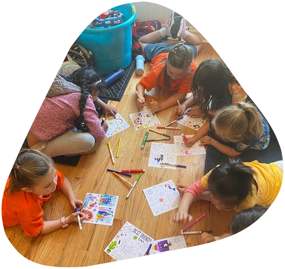 image-2 A group of children sitting on the floor and playing with paper.