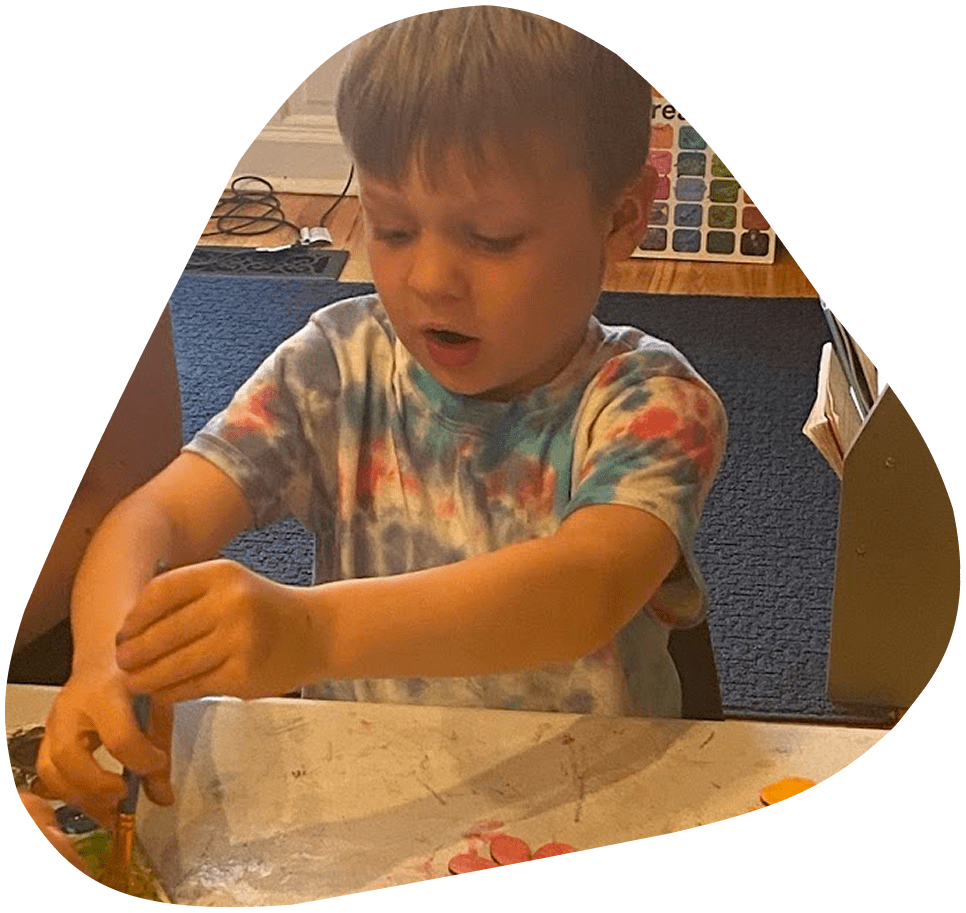 A young boy is playing with some paper