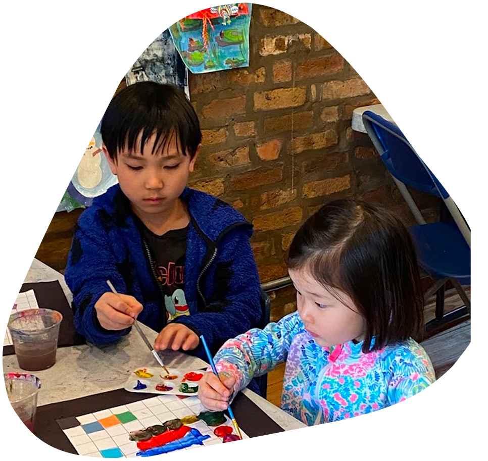 Two children are painting at a table.